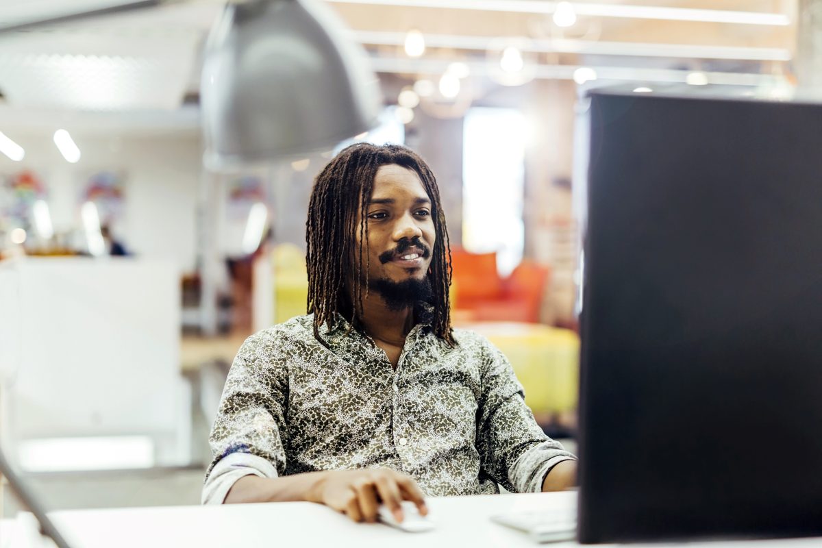 Small business owner running payroll on his computer